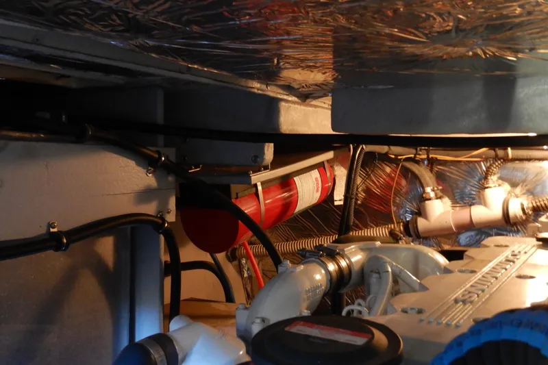 Slide: The Image of Engine room of 2008 Meridian 411 Sedan with visible fire extinguisher and mechanical components. - 50