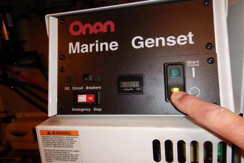 Slide: The Image of Onan Marine Genset control panel with start button on a 2008 Meridian 411 Sedan. - 52
