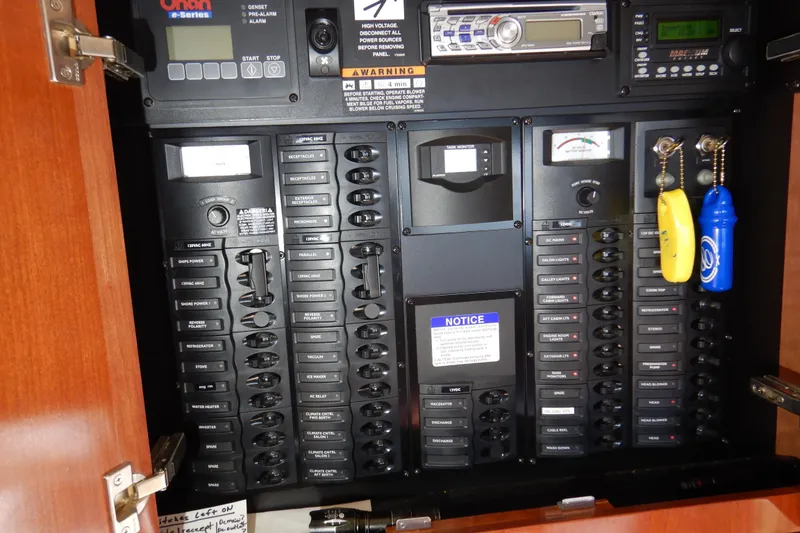 Slide: The Image of Electrical control panel inside a 2008 Meridian 411 Sedan boat, featuring switches and gauges. - 53