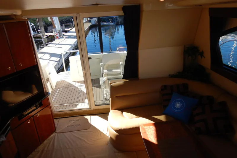 Slide: The Image of Interior of 2008 Meridian 411 Sedan yacht with cozy seating and marina view. - 6