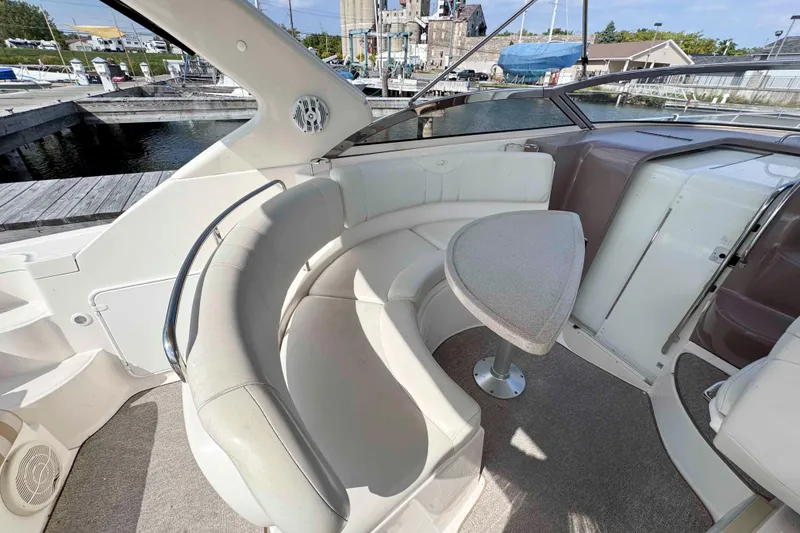 Slide: The Image of 2004 Regal Commodore 3560 yacht interior with curved seating and table at marina. - 14