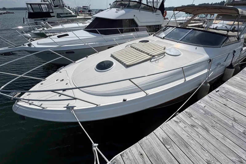 Slide: The Image of 2004 Regal Commodore 3560 yacht docked at marina, featuring sleek design and spacious deck. - 16