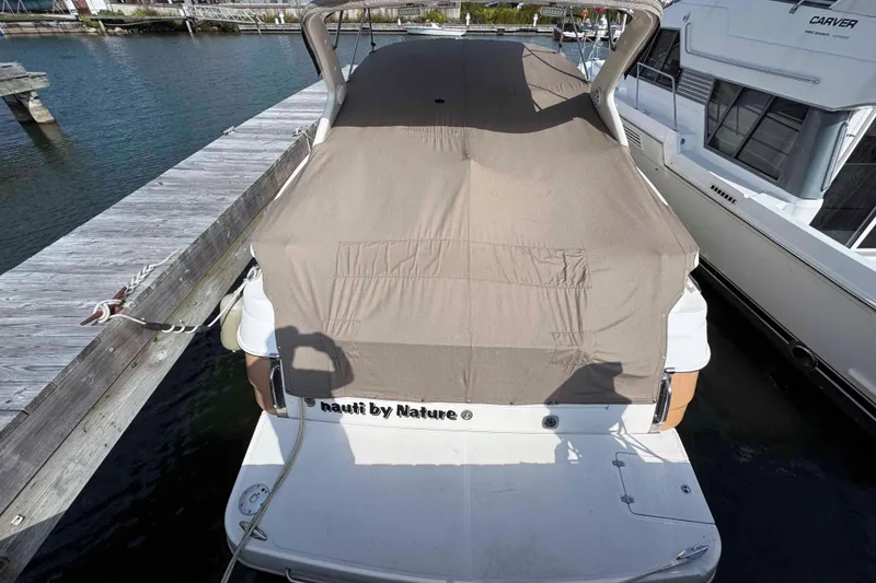 Slide: The Image of 2004 Regal Commodore 3560 boat docked, covered with a beige tarp. - 17