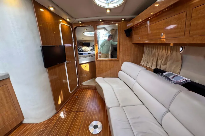Slide: The Image of Interior of 2004 Regal Commodore 3560 yacht with wood finish and white seating. - 20