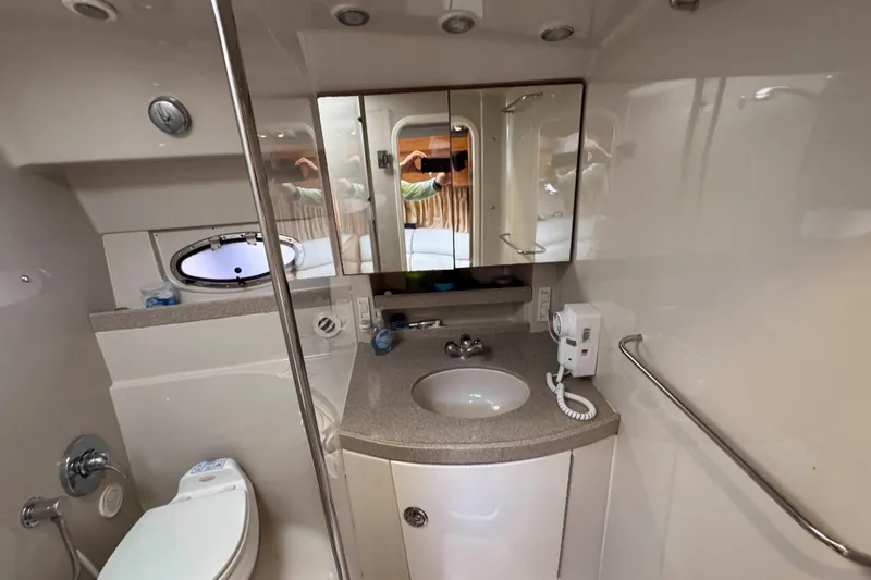 Slide: The Image of 2004 Regal Commodore 3560 yacht bathroom with sink, mirror, and toilet. - 29