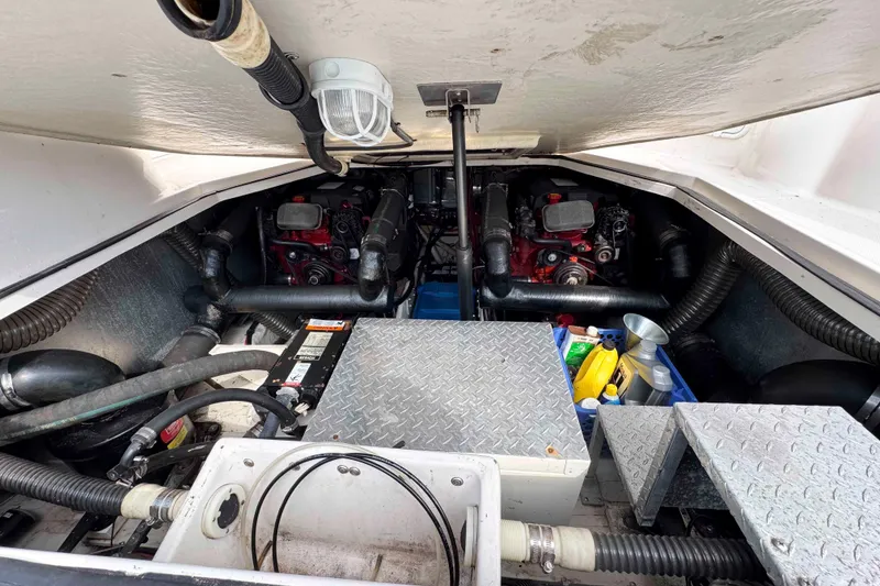 Slide: The Image of Engine compartment of 2004 Regal Commodore 3560 boat, showing dual engines and maintenance supplies. - 30