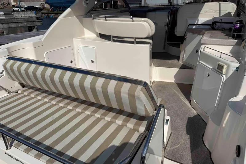 Slide: The Image of 2004 Regal Commodore 3560 boat interior with striped seating and kitchenette area. - 6