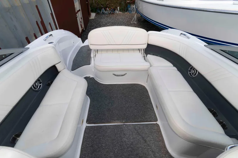 Slide: The Image of Interior of a 2007 Cobalt 252 boat with white seating and carpeted floor. - 10