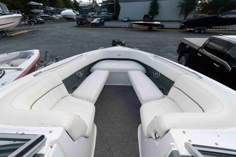 Slide: The Image of 2007 Cobalt 252 boat interior with white seating, parked in a marina. - 4