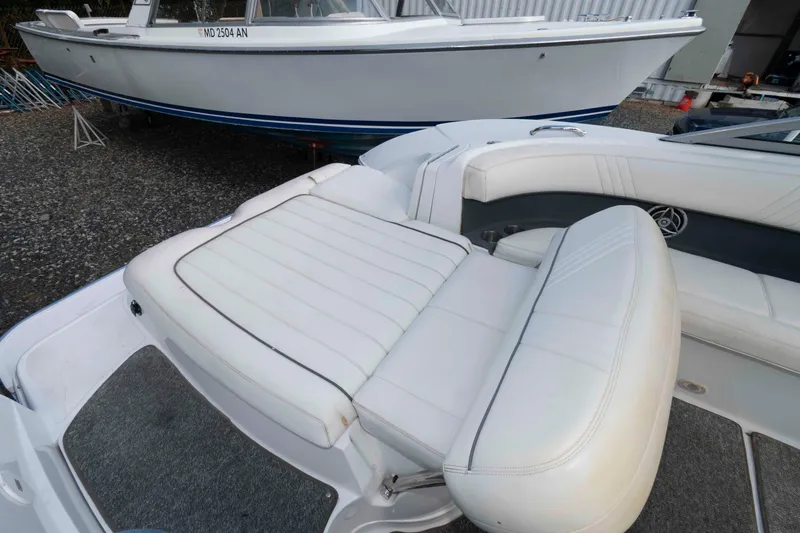 Slide: The Image of 2007 Cobalt 252 boat interior with white leather seating and carpeted flooring. - 5