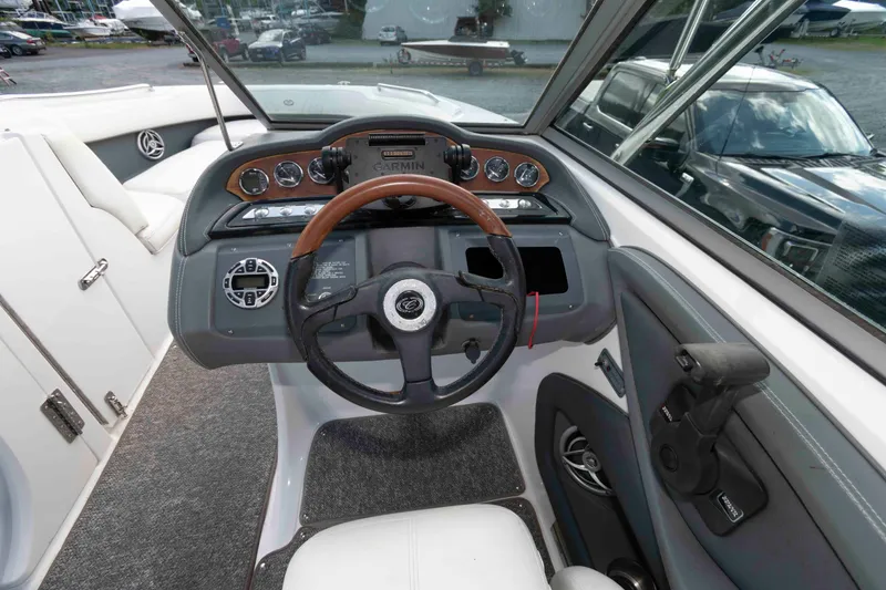 Slide: The Image of 2007 Cobalt 252 boat dashboard with steering wheel and Garmin navigation system. - 8