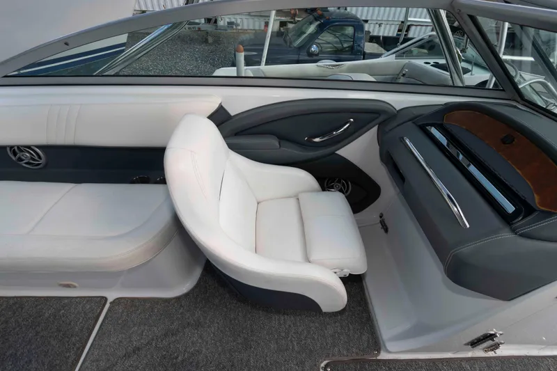 Slide: The Image of Interior of a 2007 Cobalt 252 boat with white seating and sleek dashboard design. - 9