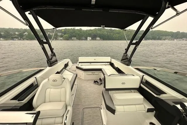 Slide: The Image of 2023 Cobalt R8 boat interior with sleek seating, docked in a marina. - 10