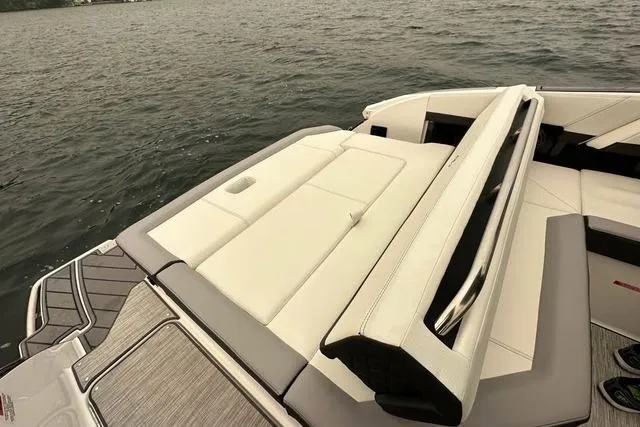 Slide: The Image of 2023 Cobalt R8 boat cockpit with modern steering and navigation system, docked at marina. - 11