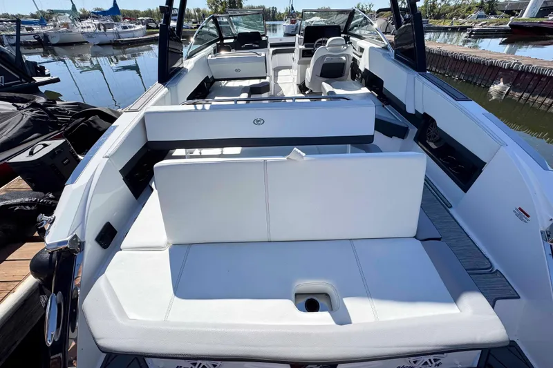 Slide: The Image of 2023 Cobalt R8 boat interior with white seating, docked at a marina. - 21