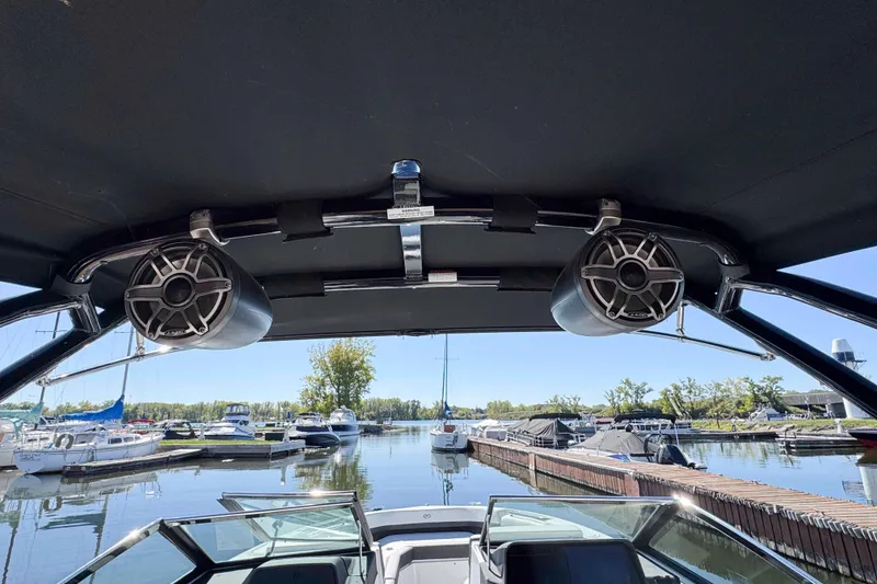 Slide: The Image of 2023 Cobalt R8 boat interior with speakers, docked at a marina. - 22