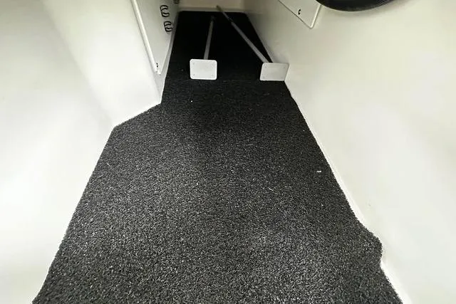 Slide: The Image of Interior of 2023 Cobalt R8 boat with black carpeted flooring. - 28