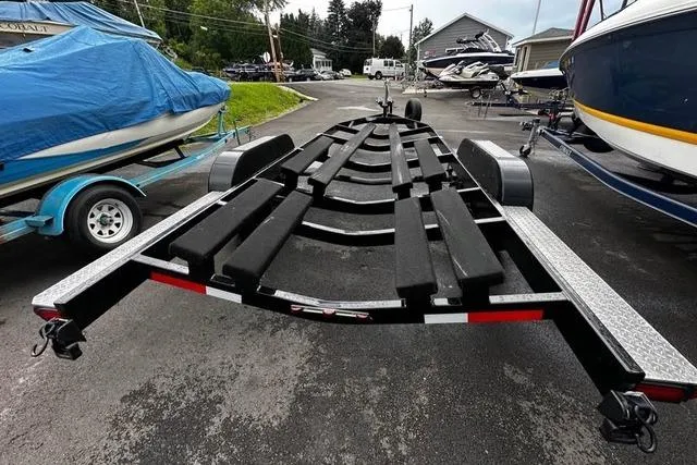 Slide: The Image of 2023 Cobalt R8 boat trailer parked in a marina with other boats. - 33