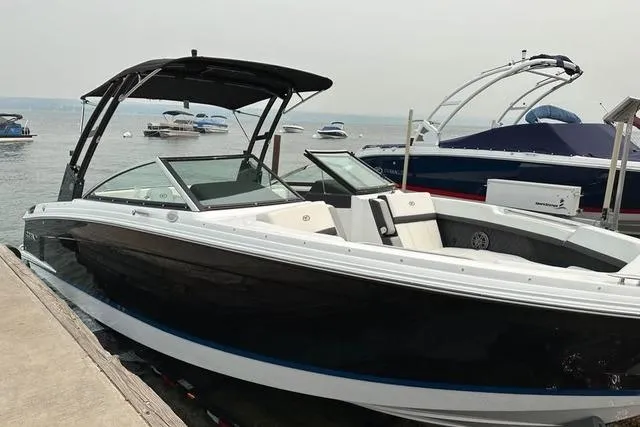 Slide: The Image of 2023 Cobalt R8 boat interior with sleek seating and modern design at a marina. - 9