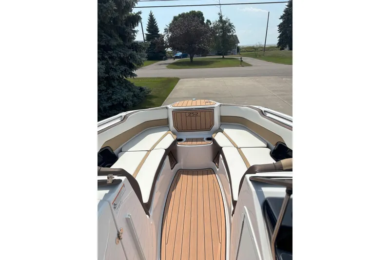Slide: The Image of 2023 Yamaha Boats 252SD interior with sleek seating and wood finish. - 14