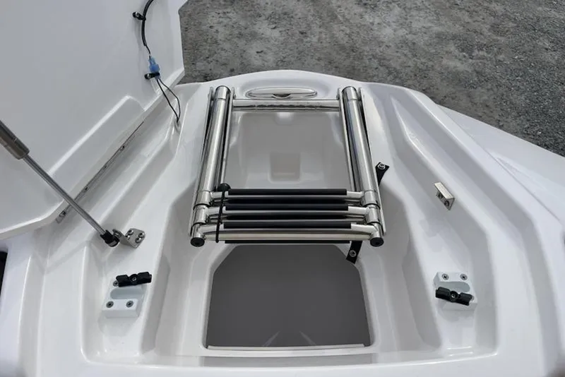 Slide: The Image of 2023 Yamaha Boats 252SD storage compartment with open hatch, showcasing interior details. - 9
