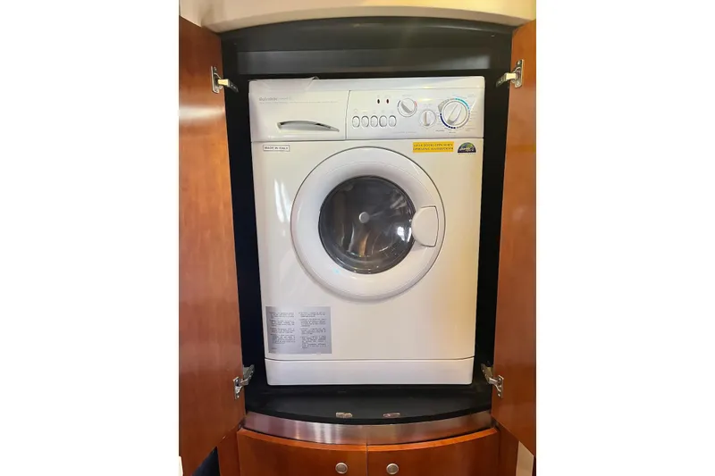 Slide: The Image of Washing machine inside 2006 Cruisers Yachts 520 Express, wooden cabinet enclosure. - 11