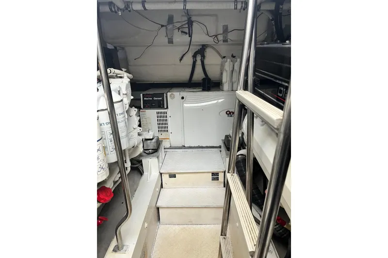 Slide: The Image of Engine room of 2006 Cruisers Yachts 520 Express with generator and equipment. - 15