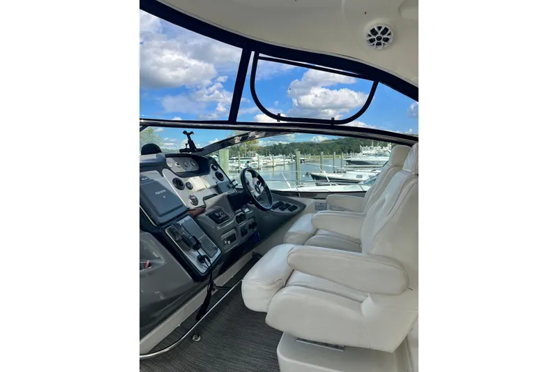 Slide: The Image of Interior of 2006 Cruisers Yachts 520 Express with white seats and control panel. - 2
