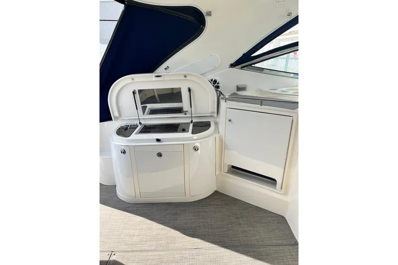 Slide: The Image of 2006 Cruisers Yachts 520 Express interior with kitchenette and storage cabinets. - 4