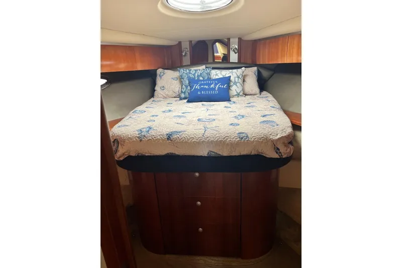 Slide: The Image of Cozy bedroom in 2006 Cruisers Yachts 520 Express with nautical-themed bedding. - 5