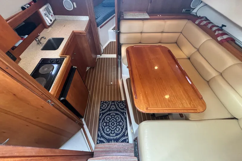 Slide: The Image of 2005 Mainship Pilot 34 helm with steering wheel and navigation controls. - 13