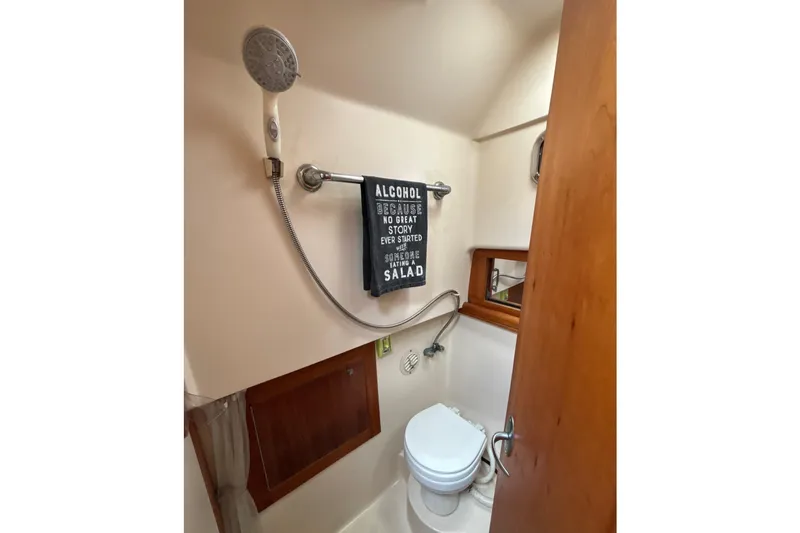 Slide: The Image of Cozy cabin interior of 2005 Mainship Pilot 34 with wooden accents and bedding. - 26