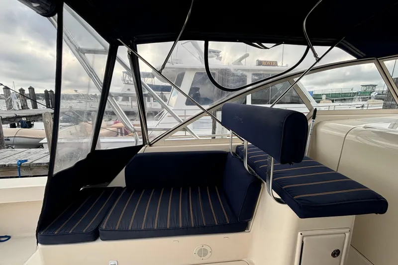 Slide: The Image of 2005 Mainship Pilot 34 boat deck with storage hatches, docked at marina. - 9