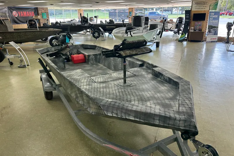 Slide: The Image of 2025 WeldBilt 1652 boat on display in showroom with other boats. - 5