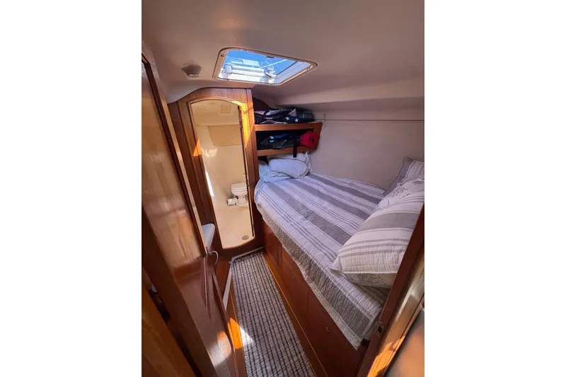 Slide: The Image of Cozy cabin interior of 2002 Hunter 410 sailboat with bed and skylight. - 11