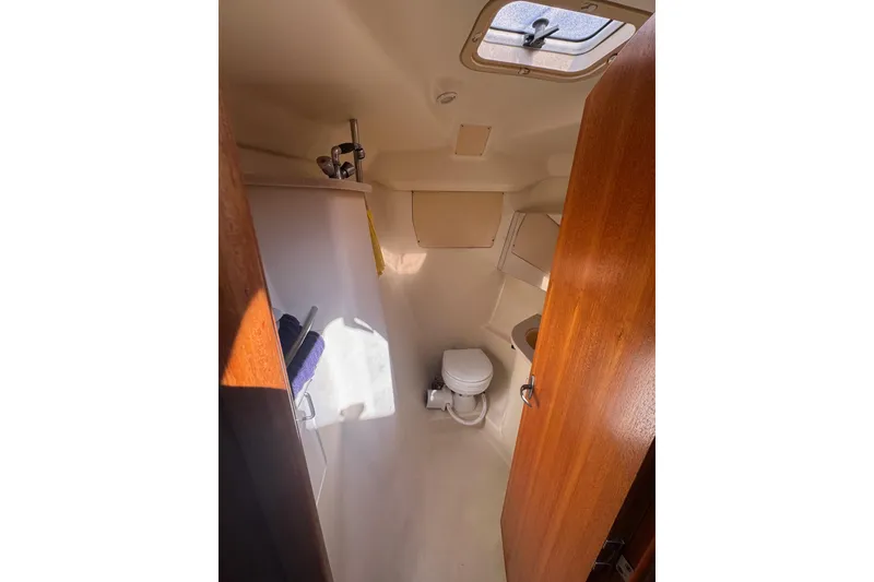 Slide: The Image of Compact bathroom interior of 2002 Hunter 410 sailboat with toilet and sink. - 12
