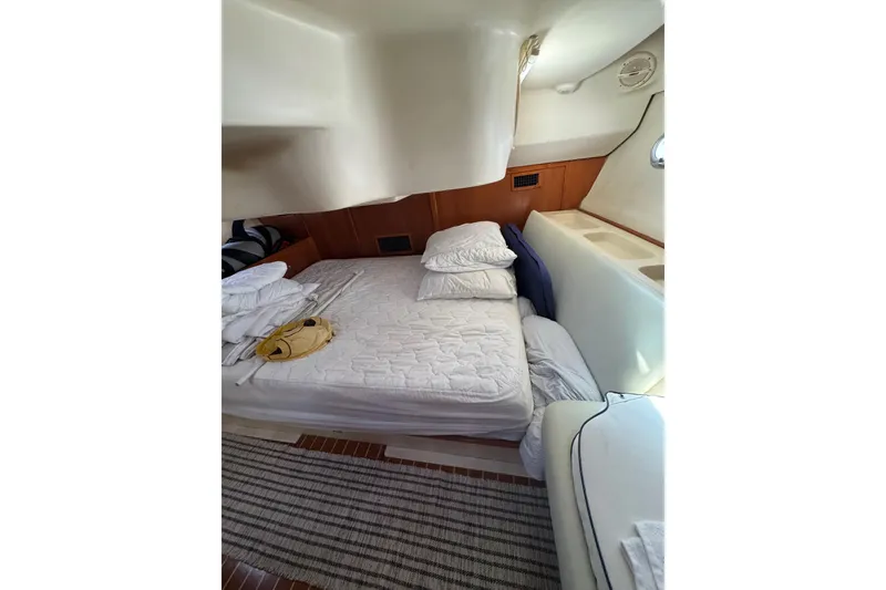 Slide: The Image of Cozy cabin interior of 2002 Hunter 410 sailboat with bed and wooden accents. - 9