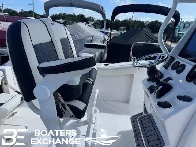 Slide: The Image of 2023 Tidewater 232 CC Adventure boat interior with helm and seating at Boaters Exchange. - 6