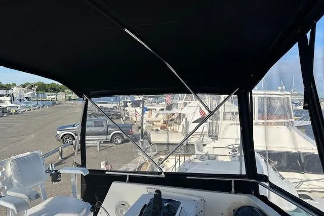 Slide: The Image of 1986 Egg Harbor 37 Convertible yacht interior view at marina. - 13