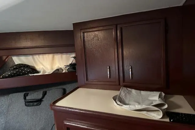 Slide: The Image of Interior of 1986 Egg Harbor 37 Convertible with wooden cabinets and storage space. - 27