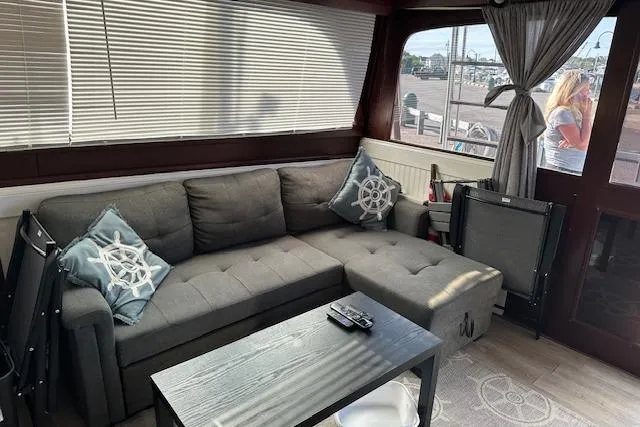 Slide: The Image of Interior of 1986 Egg Harbor 37 Convertible with gray sofa and nautical decor. - 29