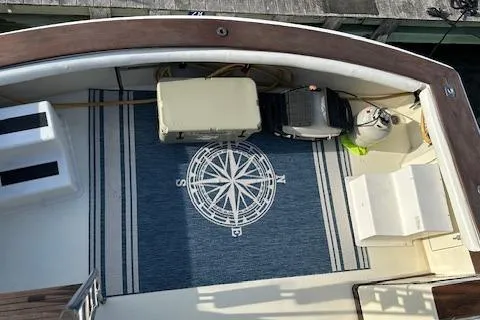 Slide: The Image of 1986 Egg Harbor 37 Convertible boat deck with nautical-themed rug and equipment. - 31