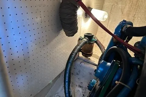 Slide: The Image of Engine room of 1986 Egg Harbor 37 Convertible boat, showing mechanical components and lighting. - 34