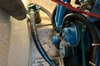 Slide: The Image of Engine compartment of a 1986 Egg Harbor 37 Convertible boat, showing hoses and mechanical components. - 35