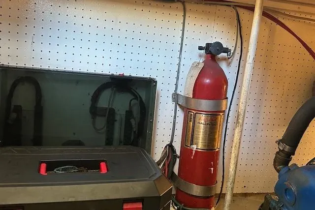 Slide: The Image of Engine room of 1986 Egg Harbor 37 Convertible with fire extinguisher and equipment. - 5