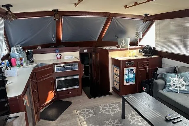 Slide: The Image of Interior of 1986 Egg Harbor 37 Convertible yacht with kitchen and seating area. - 6