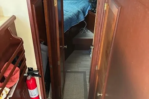 Slide: The Image of 1986 Egg Harbor 37 Convertible interior with wood finish and blue bedding. - 7