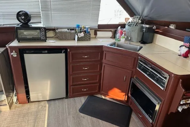 Slide: The Image of 1986 Egg Harbor 37 Convertible yacht kitchen with appliances and wooden cabinetry. - 9
