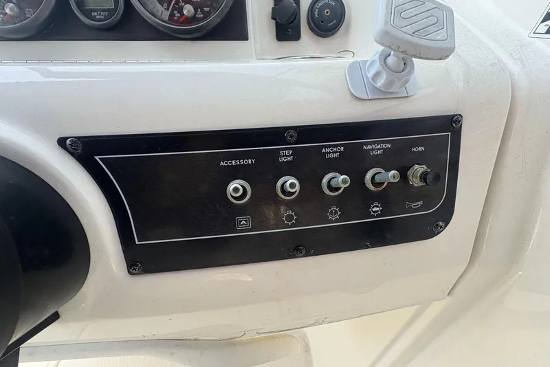 Slide: The Image of Control panel of 2016 Bayliner 215 Deck Boat with switches for lights and horn. - 22