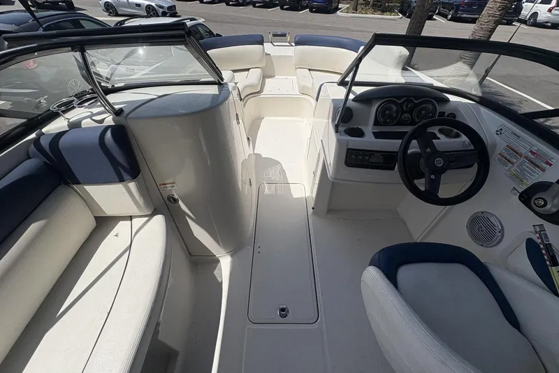 Slide: The Image of 2016 Bayliner 215 Deck Boat interior with seating and steering console. - 25